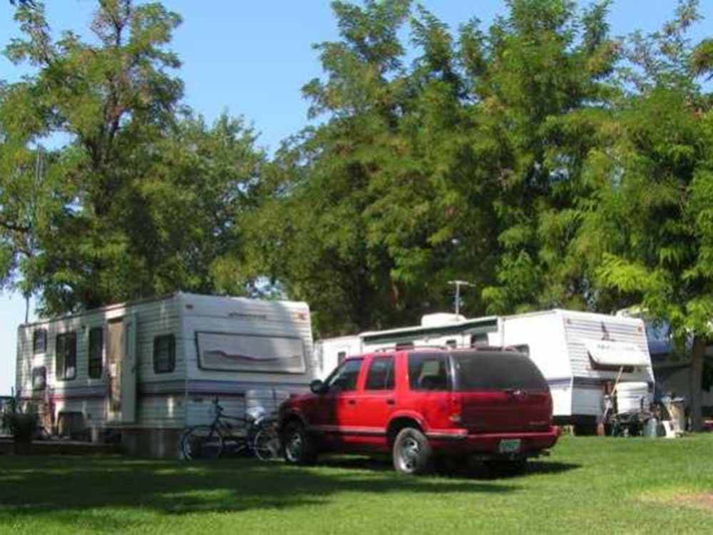 A line of travel trailers at HAT ROCK CAMPGROUND
