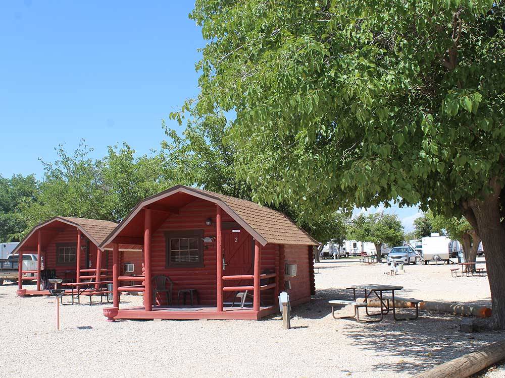 Two of the rustic rental cabins at CARLSBAD RV PARK & CAMPGROUND