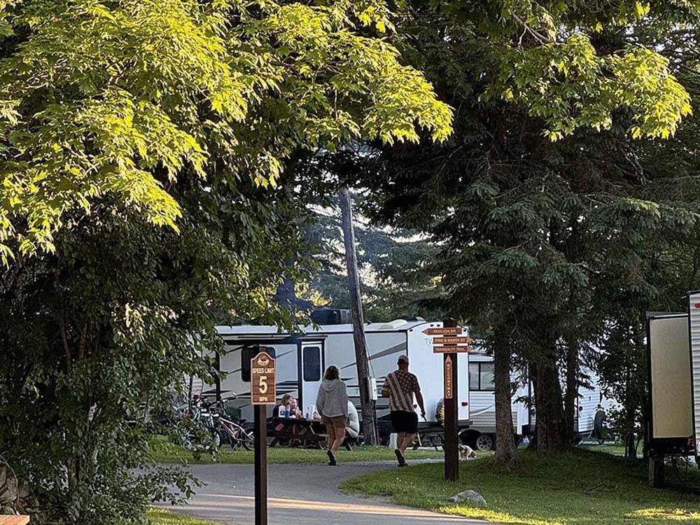 A couple walking by shaded RV sites
