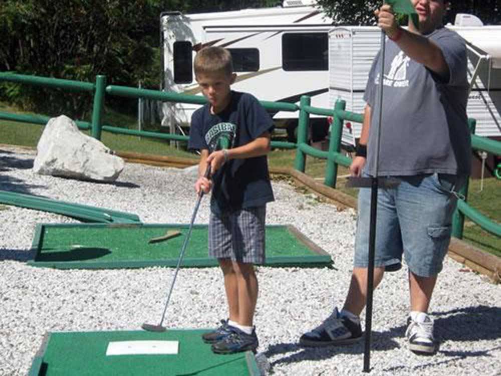 Man and boy playing mini golf at LONE PINE CAMPSITES