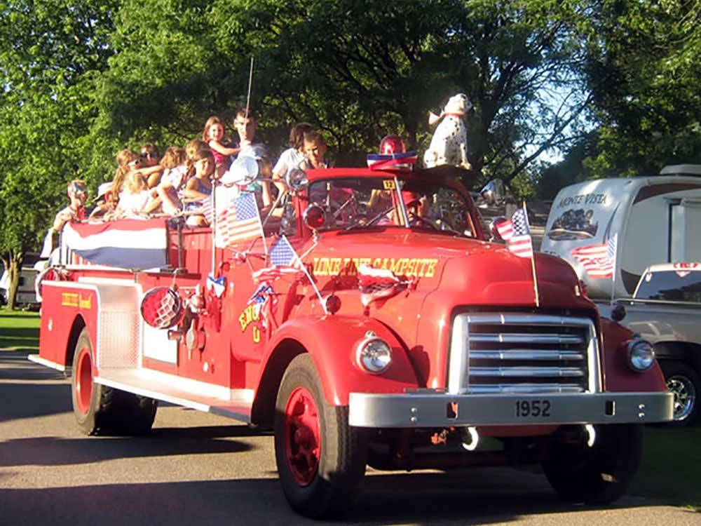 People riding in a fire truck at LONE PINE CAMPSITES