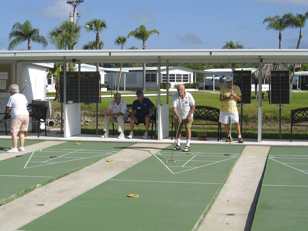 Couples playing shuffleboard at ENCORE FORT MYERS BEACH