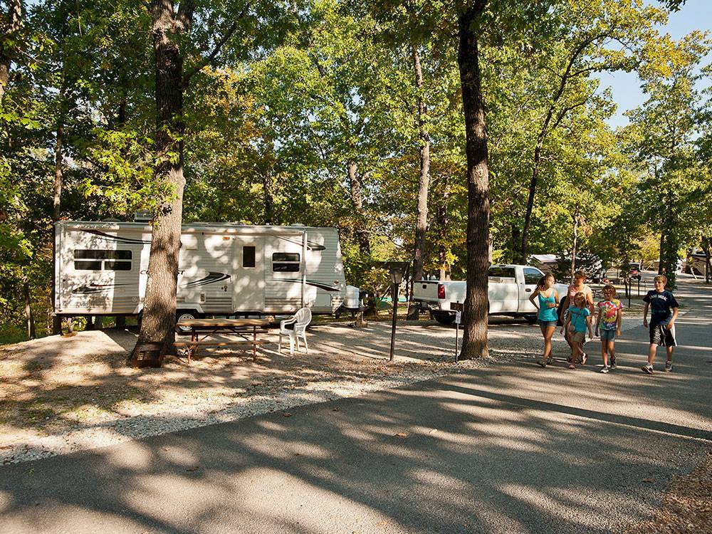 People walking in the road past RV sites