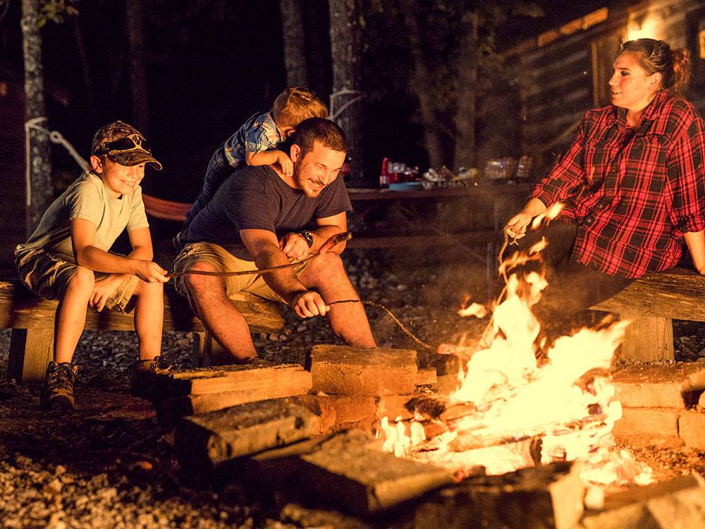 A family around a fire at night