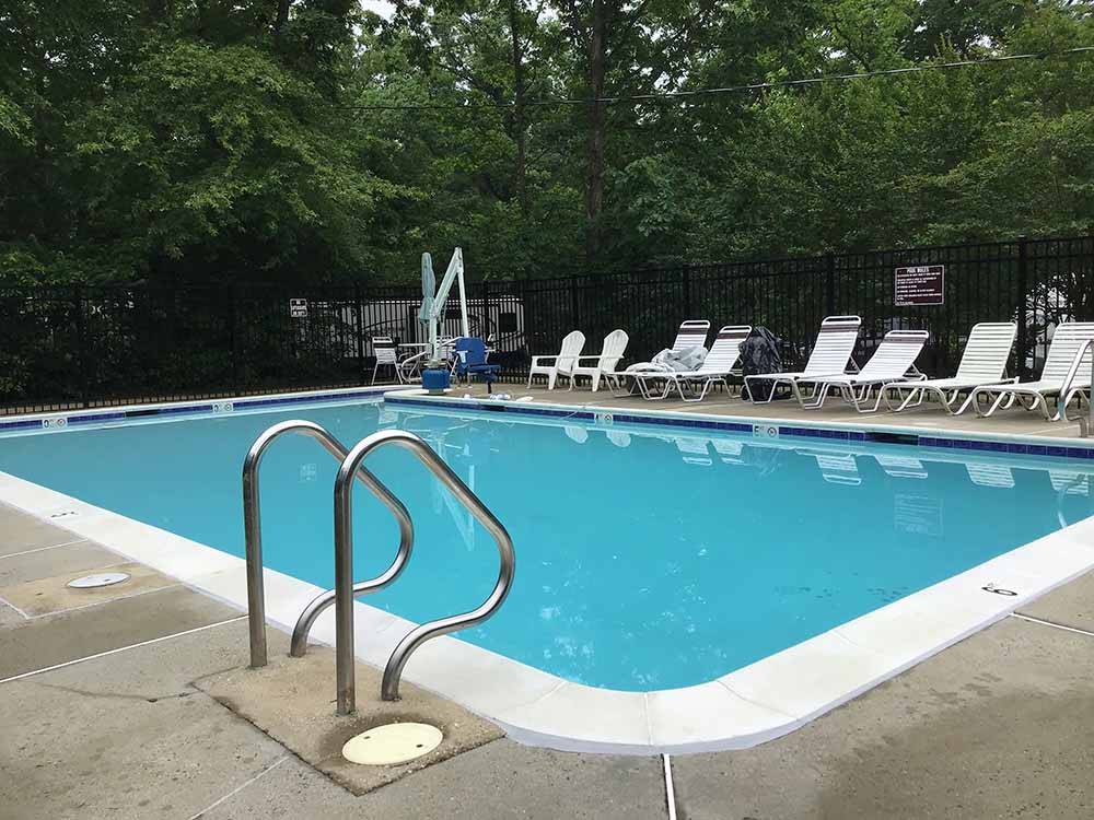 Lounge chairs around the pool at PRINCE WILLIAM FOREST RV CAMPGROUND