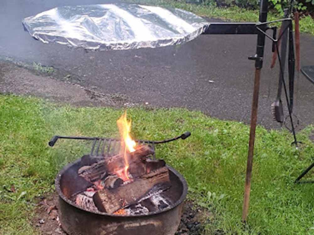 Cooking food over an open fire at PRINCE WILLIAM FOREST RV CAMPGROUND