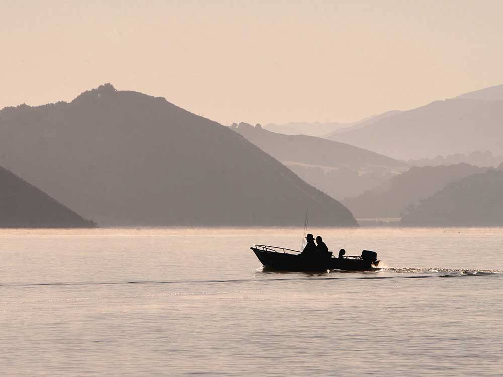 Two people fishing from a boat at CACHUMA LAKE CAMPGROUND