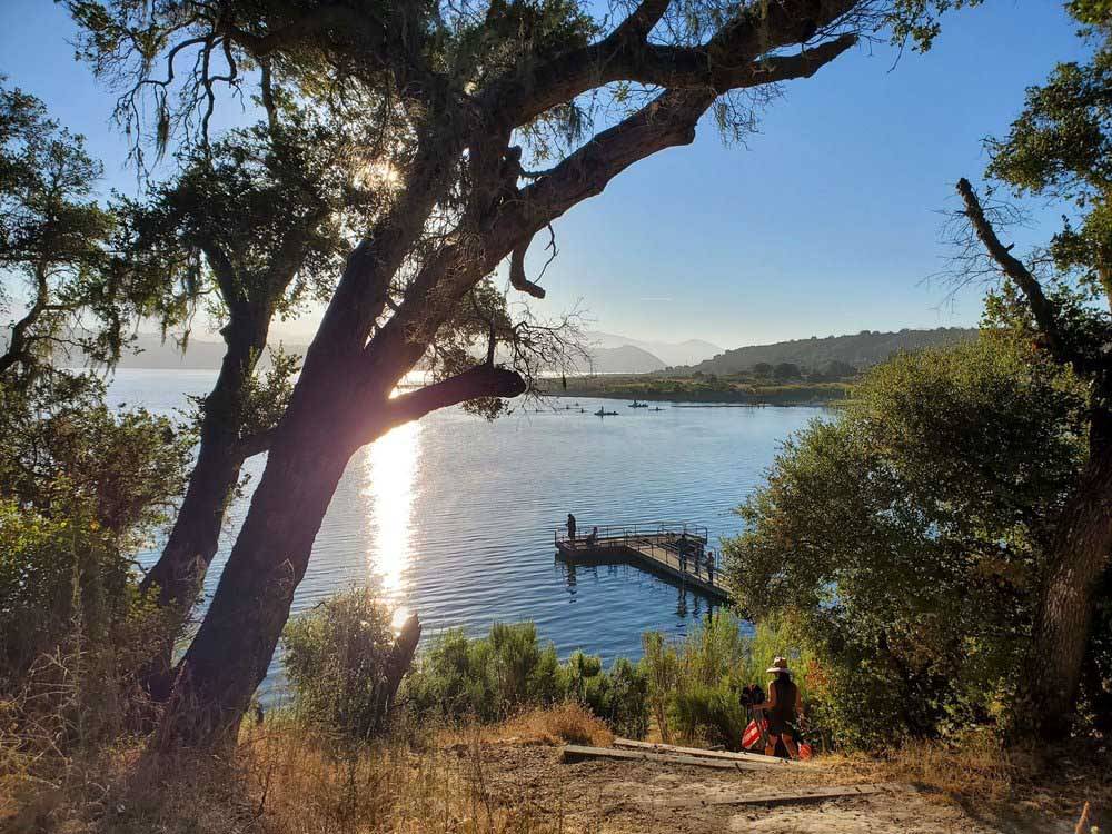 Person fishing off pier in the distance at CACHUMA LAKE CAMPGROUND