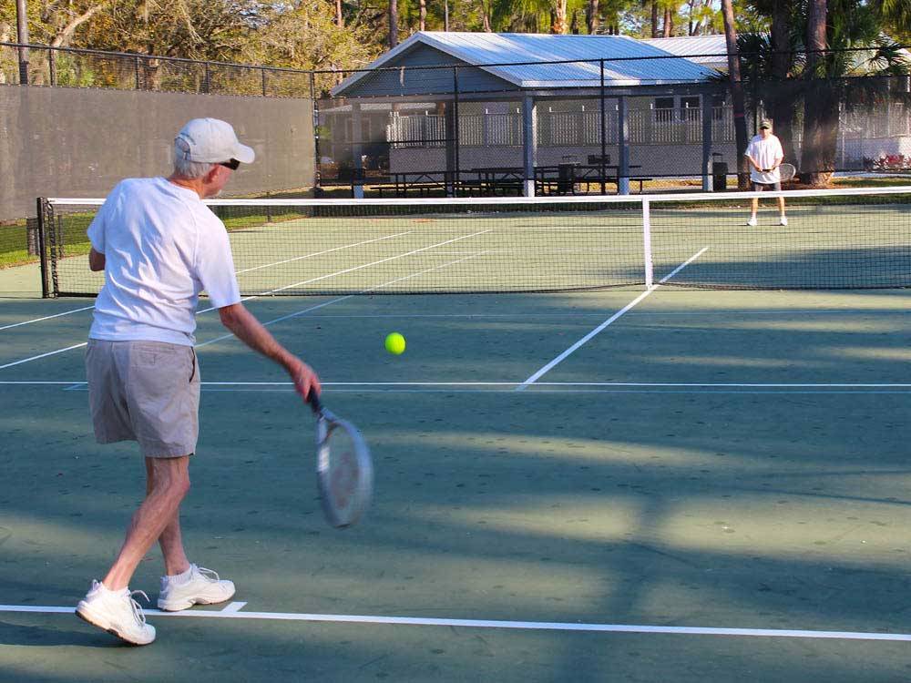 Couple playing tennis at ENCORE RAMBLERS REST