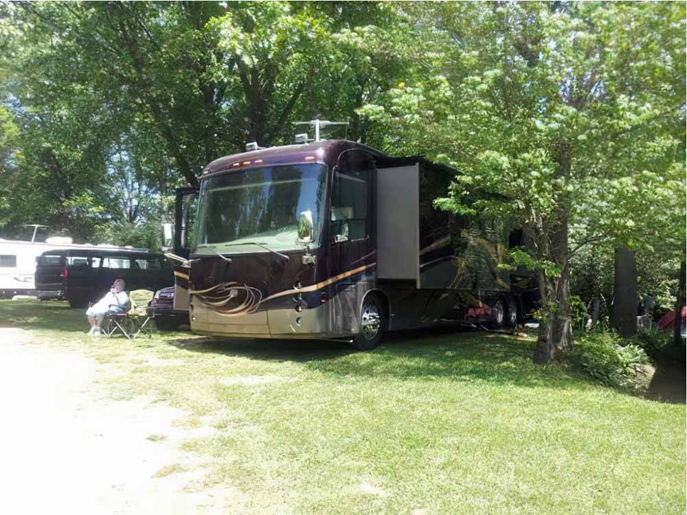 A motorhome in a back in RV site at CAMP TOODIK FAMILY CAMPGROUND, CABINS & CANOE LIVERY