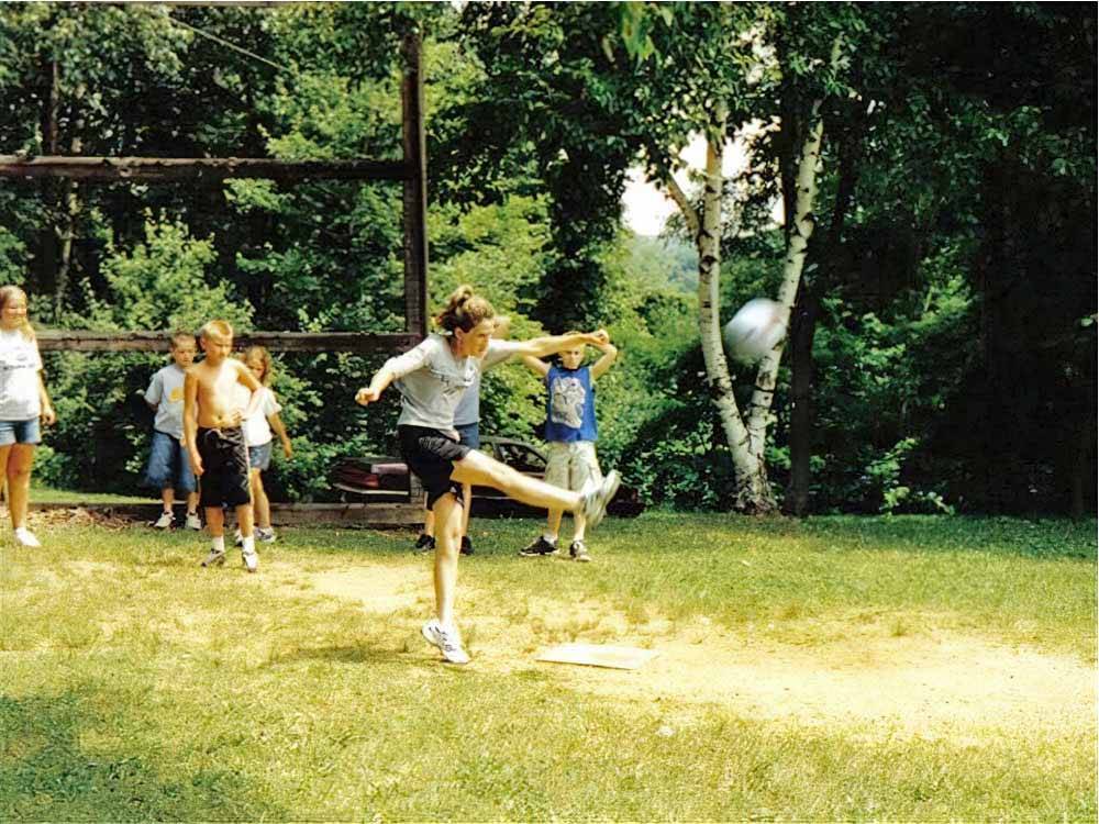 A girl kicking a soccer ball at CAMP TOODIK FAMILY CAMPGROUND, CABINS & CANOE LIVERY