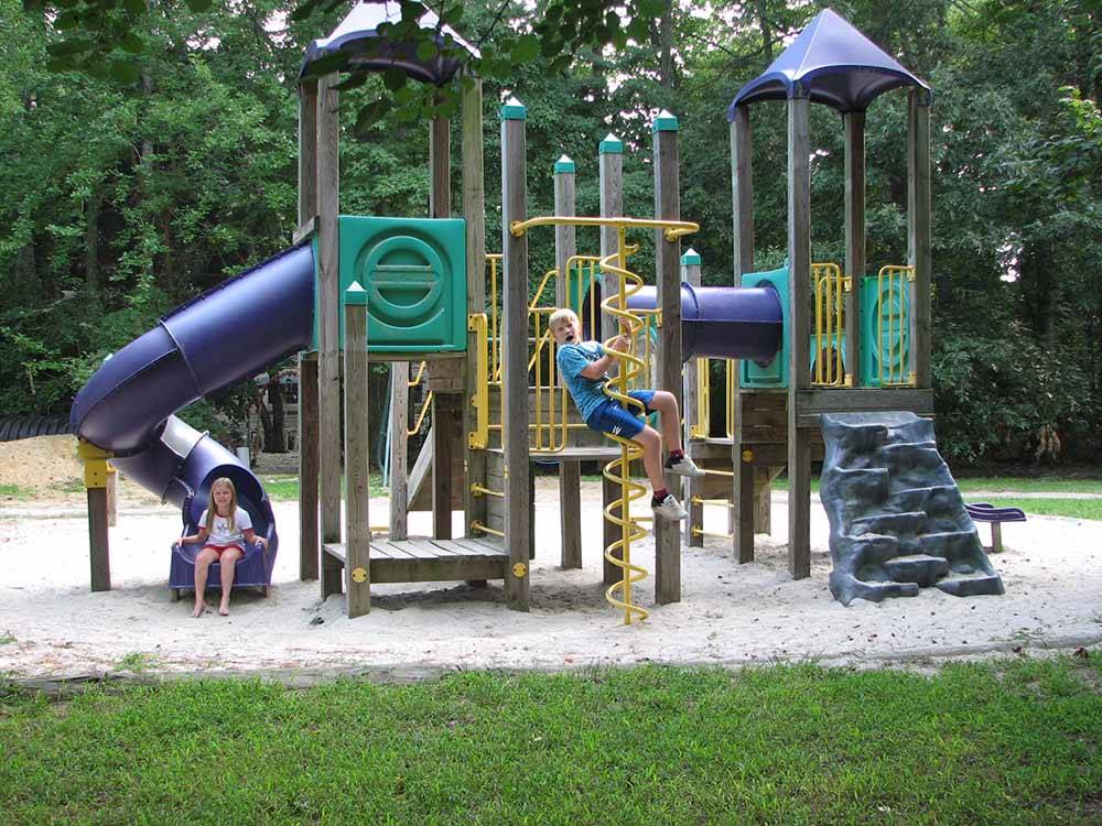 Kids playing on the playground equipment at ACORN CAMPGROUND