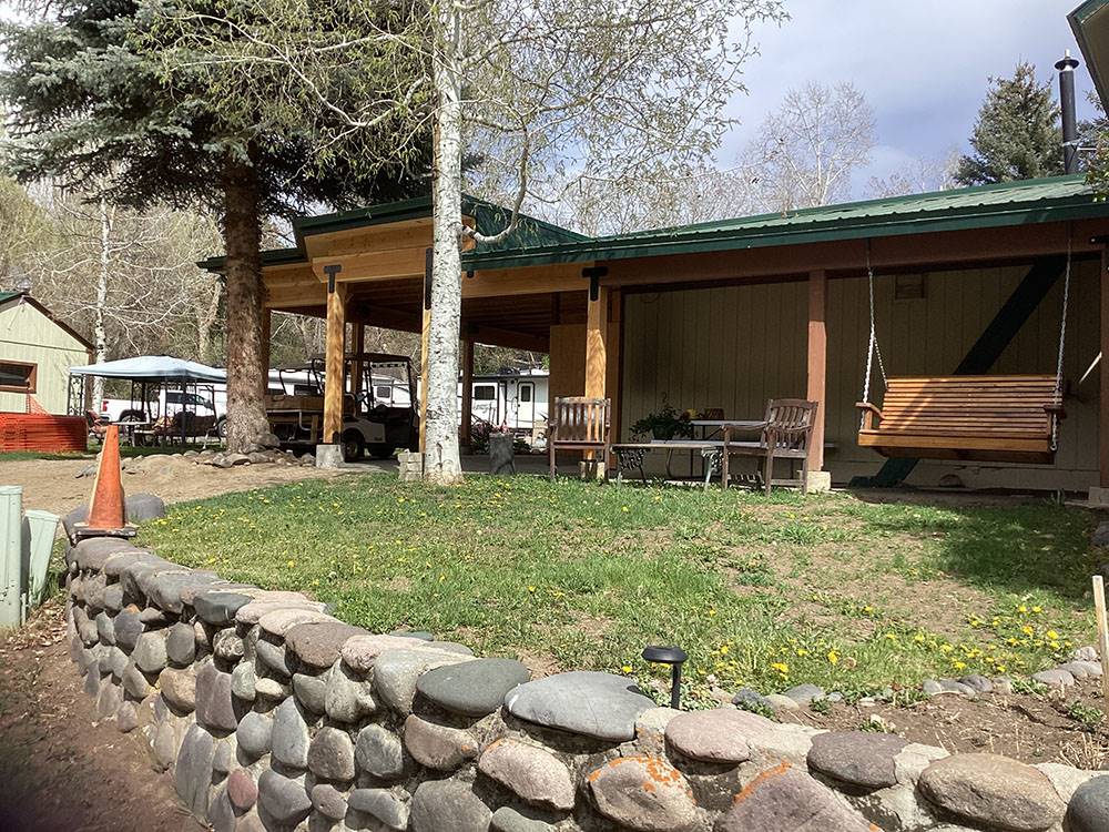 Stone wall in front of building at Pagosa Riverside Campground