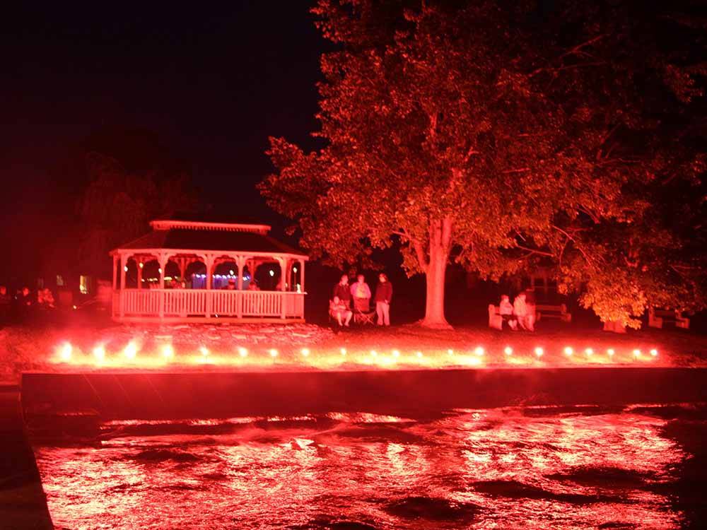 The gazebo at night with red lights at THE "WILLOWS" ON THE LAKE RV PARK & RESORT