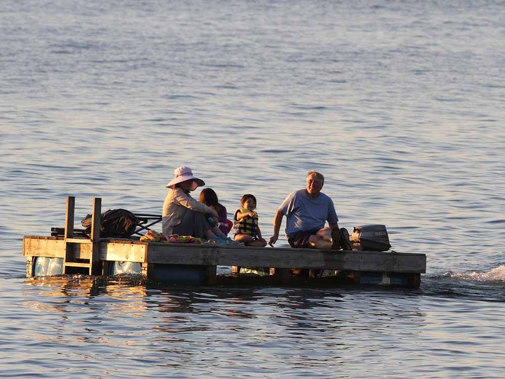A group of people on a motorized swimming dock at THE "WILLOWS" ON THE LAKE RV PARK & RESORT