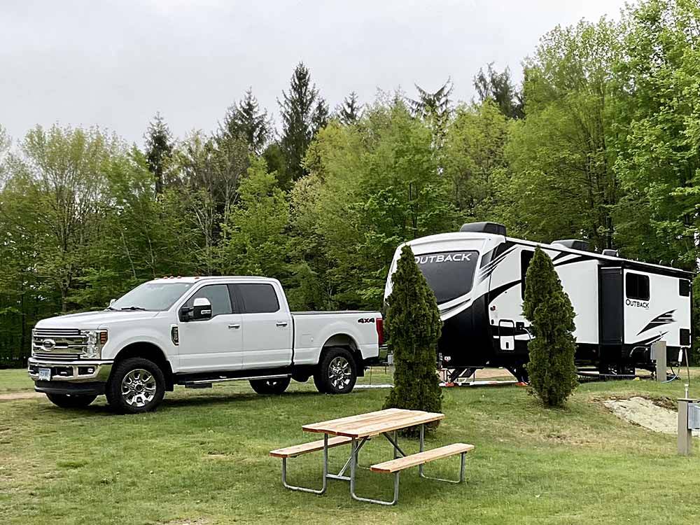 A truck and travel trailer at OAK HAVEN FAMILY CAMPGROUND