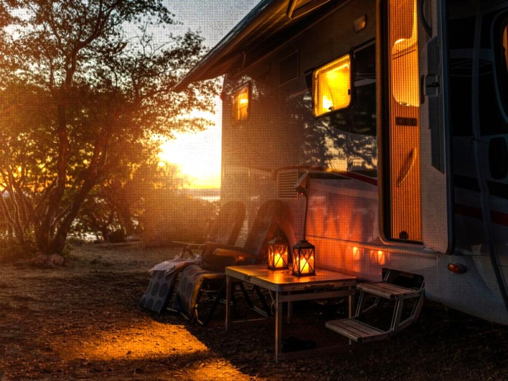 Parked RV with sun setting at Antlers Resort & RV Park