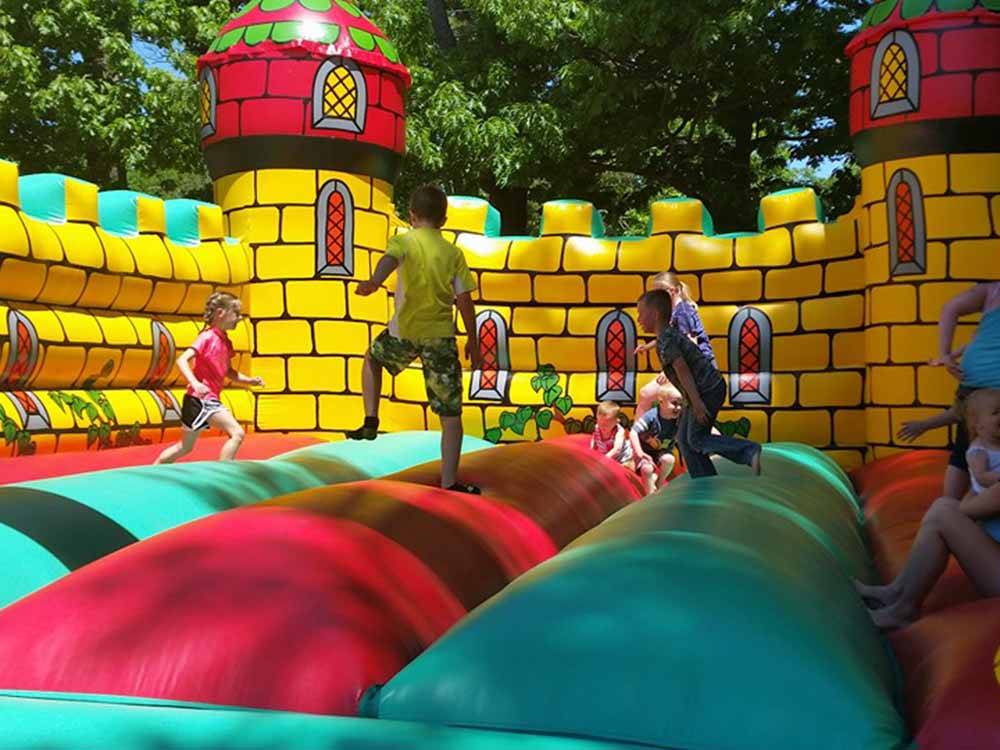 Kids playing in the bounce house at MEADOWBROOK CAMPING AREA