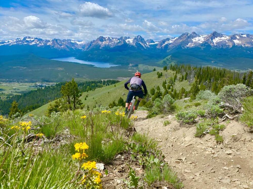 A person mountain biking at Smiley Creek Lodge