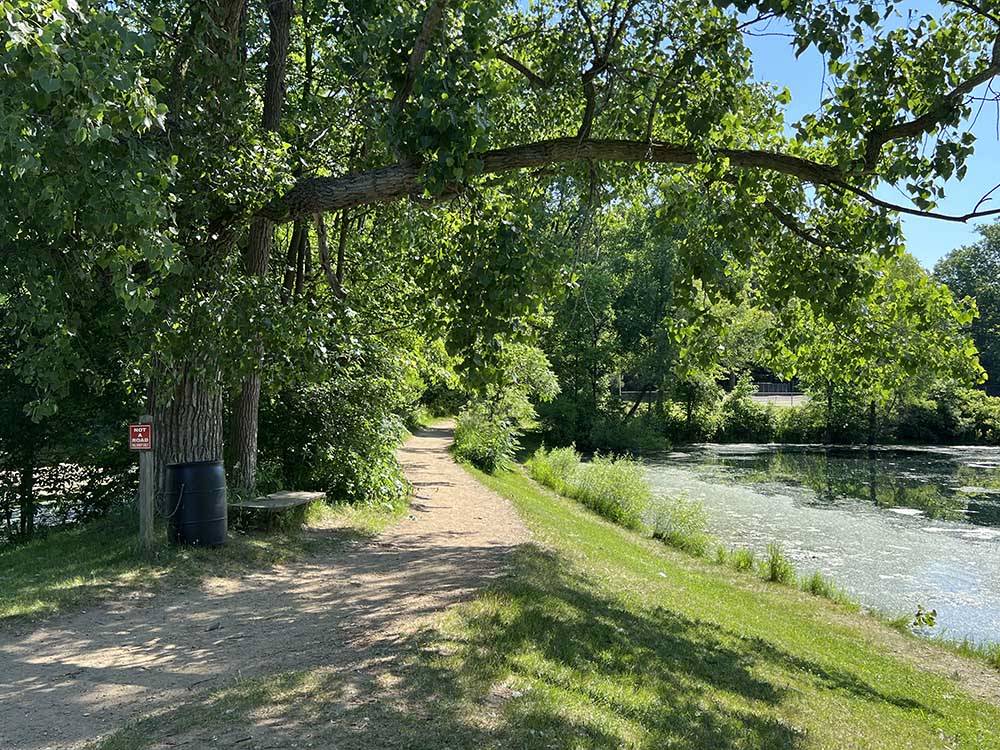 A dirt walking path by the water at LANSING COTTONWOOD CAMPGROUND