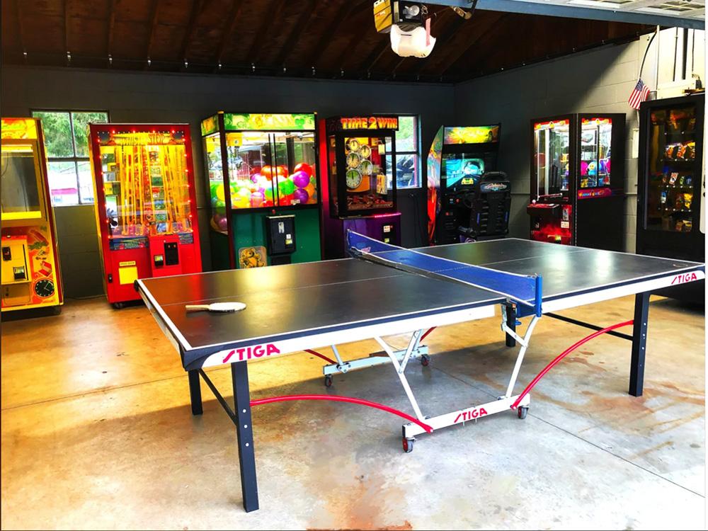 Arcade games and ping pong table in the rec room at WHIPPOORWILL MOTEL & CAMPSITES