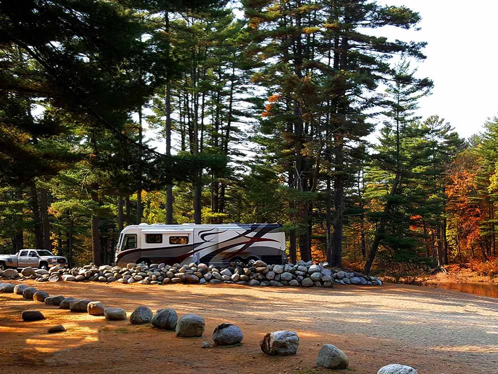 An empty gravel RV site at LAKE GEORGE RIVERVIEW CAMPGROUND