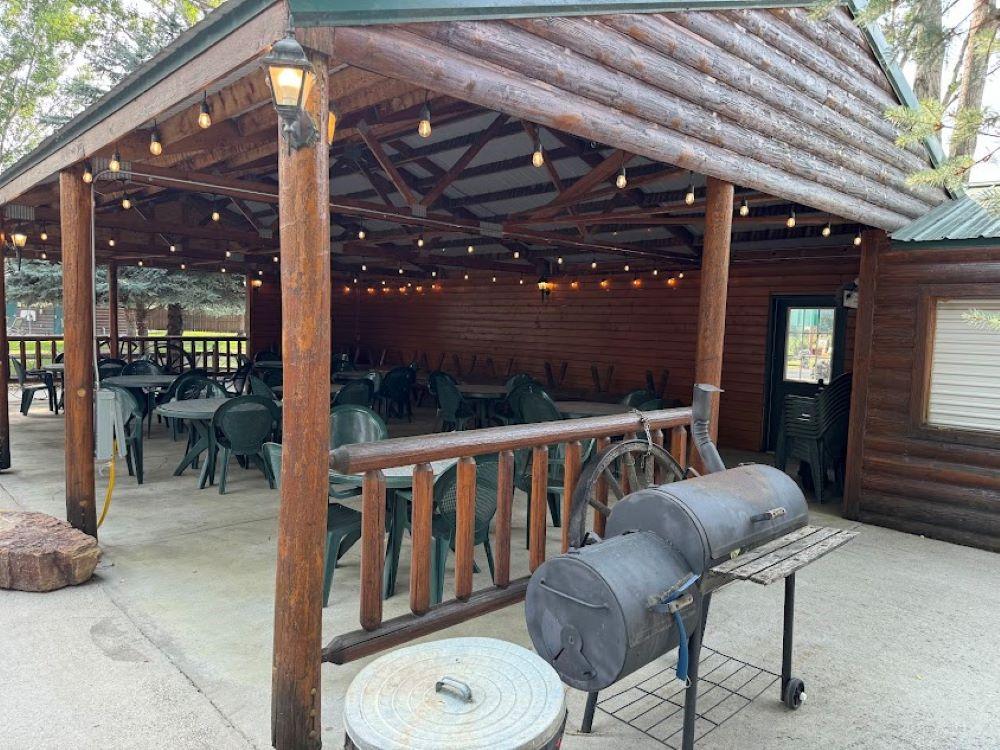 Barbeque grill and covered eating area at YELLOWSTONE RIVER RV PARK & CAMPGROUND