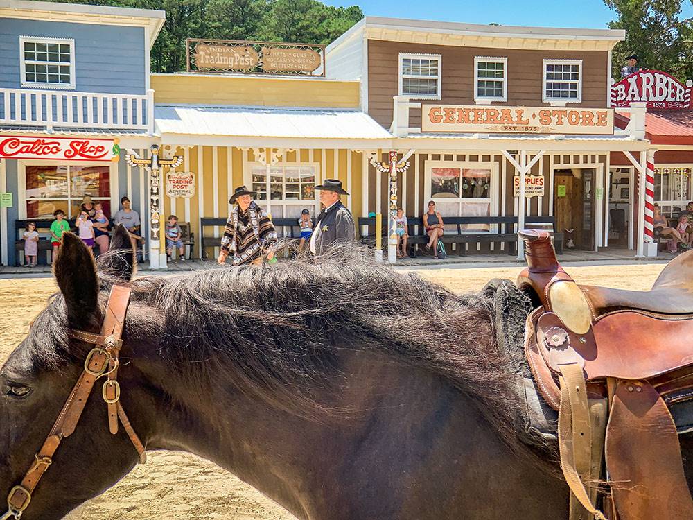 Two men acting out a western show nearby at SUN OUTDOORS FRONTIER TOWN