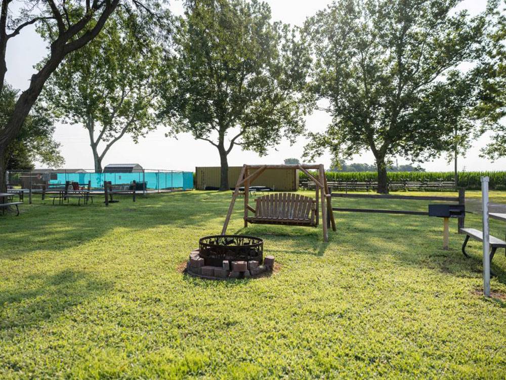 A lounge swing near a fire ring