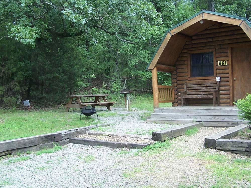 Cabin with picnic table and gravel parking space at FORT SMITH-ALMA RV PARK