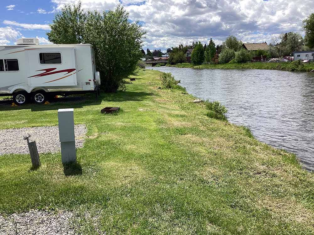 Back in gravel RV sites by the river at DEER LODGE A-OK CAMPGROUND