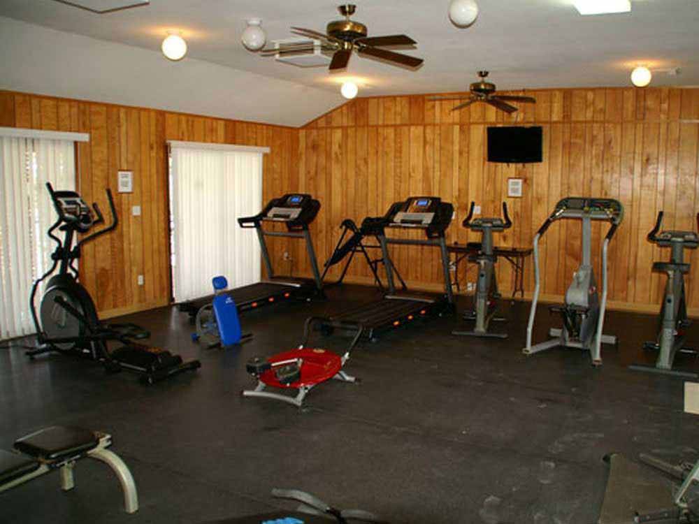 A wood paneled exercise room at HITCHIN' POST RV PARK