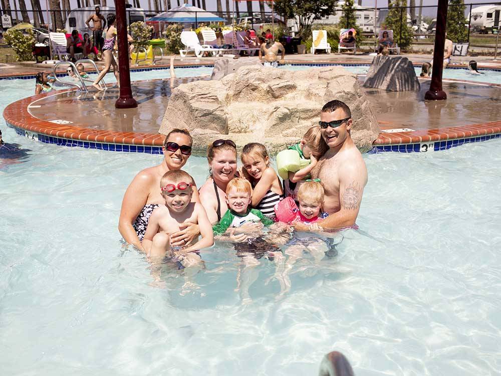 A family standing in the pool at SUN OUTDOORS CAPE CHARLES