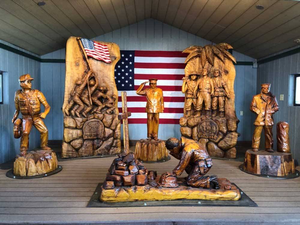 Wooden statues of military people at USA RV PARK