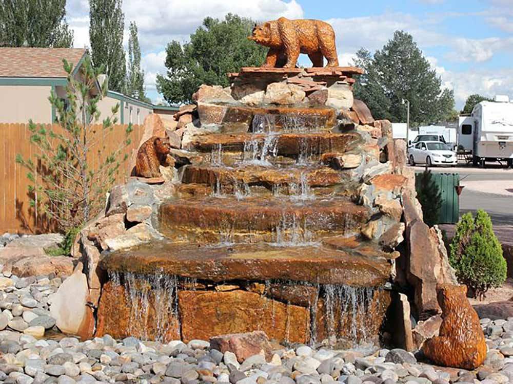 Tiered rock water feature with carved stone bears at USA RV PARK