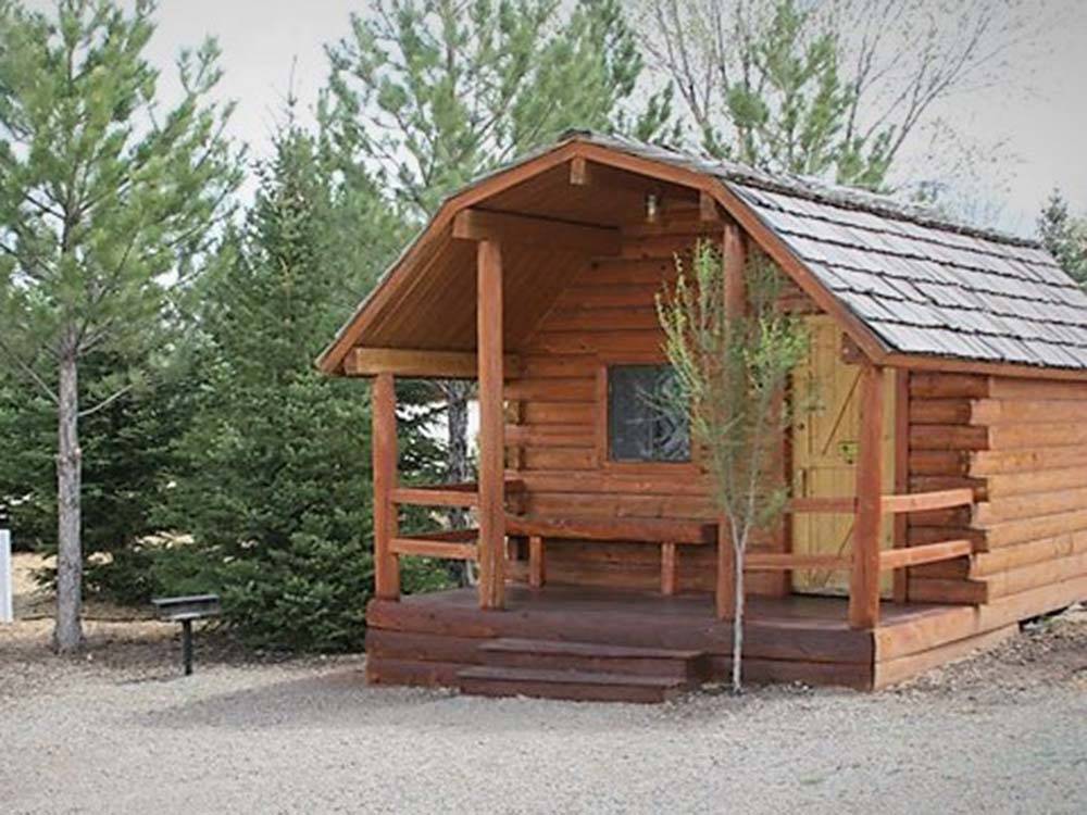 A rental cabin surrounded by trees at CORTEZ RV RESORT BY RJOURNEY