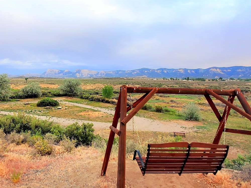 A swing to look at the mountains at CORTEZ RV RESORT BY RJOURNEY