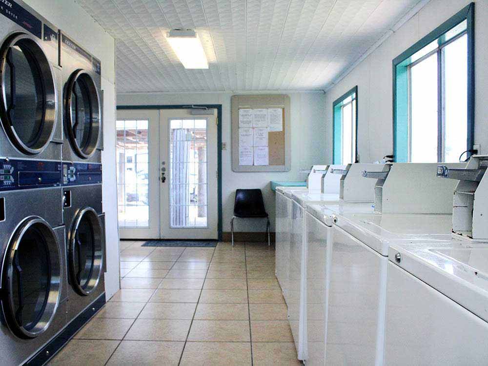 Laundry room with washer and dryers at PADRE PALMS RV PARK