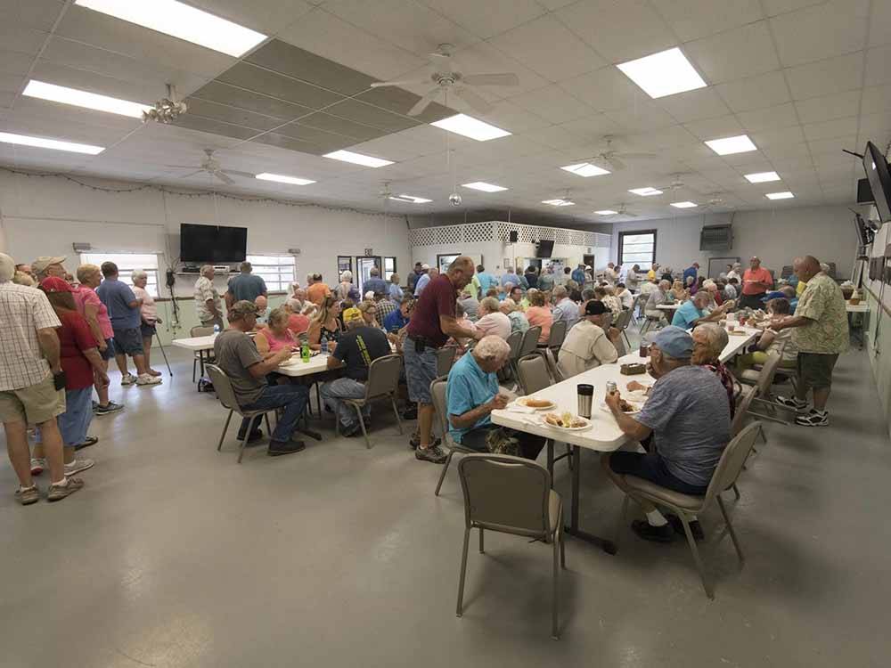 People enjoying meals in the cafeteria at OAK HARBOR RV VILLAGE