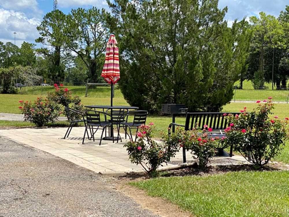 Outdoor bench, tables and chairs set up at JENNINGS KOA HOLIDAY