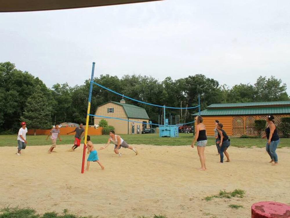 Group of people playing sand volleyball at BUTTERFLY CAMPING RESORT