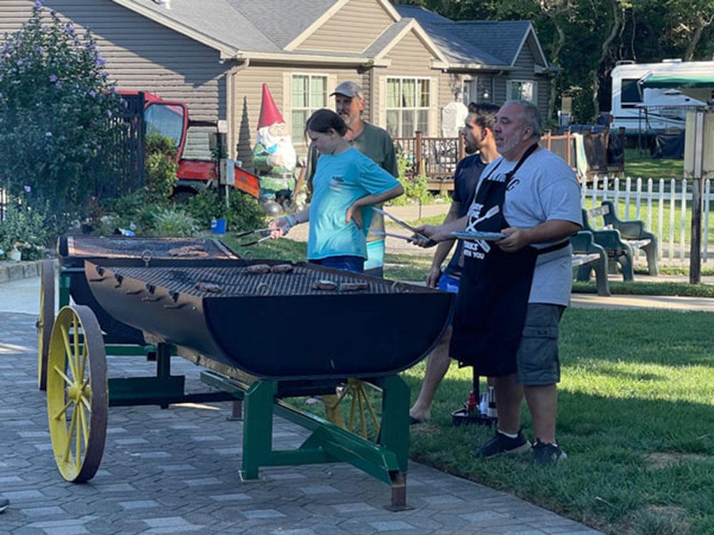 People grilling on large grills at BUTTERFLY CAMPING RESORT