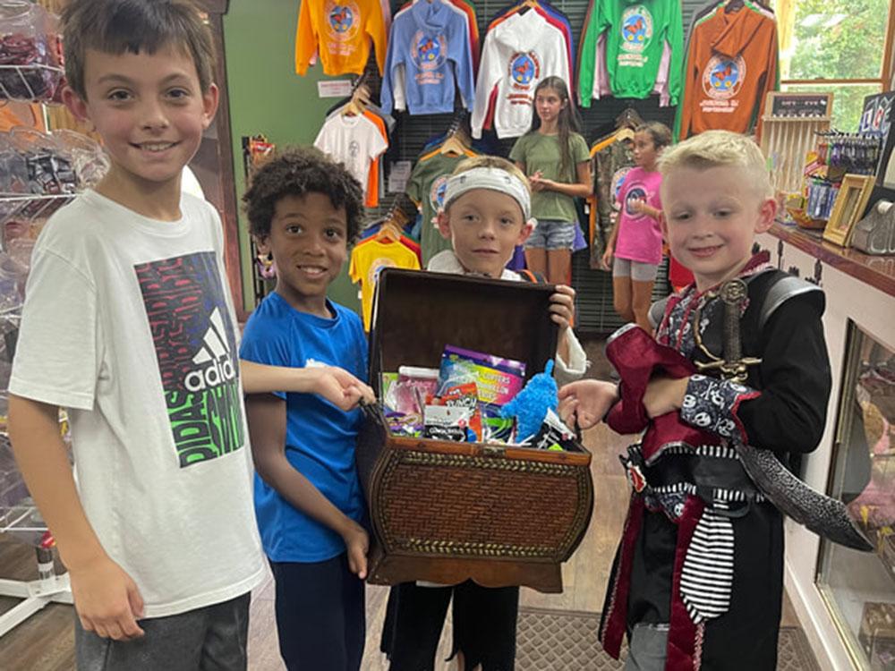 Children in store showing their treasures at BUTTERFLY CAMPING RESORT