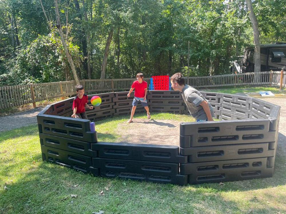 Children playing ball in an enclosed space at BUTTERFLY CAMPING RESORT