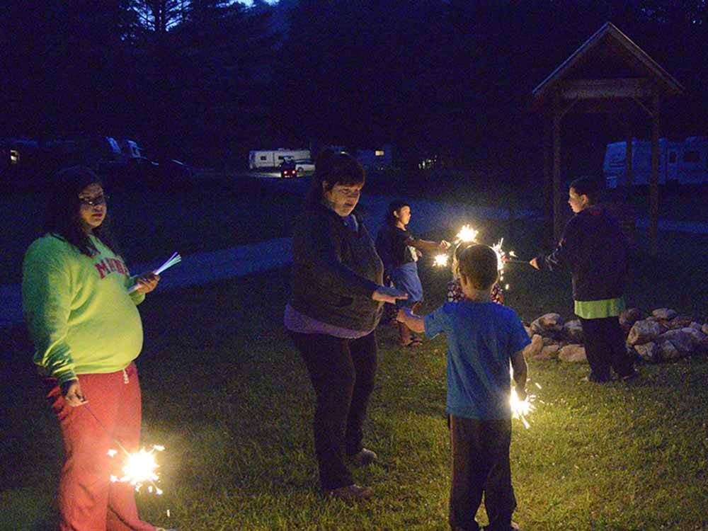 Kids playing with sparklers at HORSESHOE ACRES