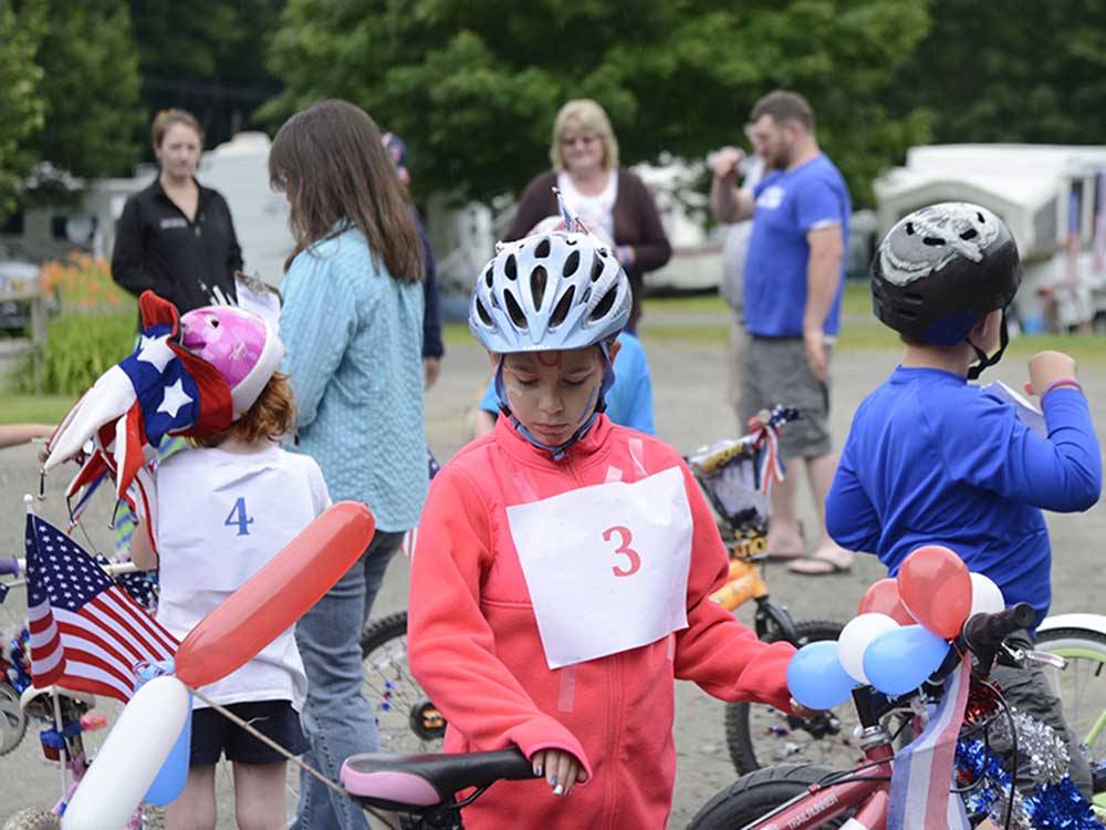 Kid riding their bikes in a parade at HORSESHOE ACRES