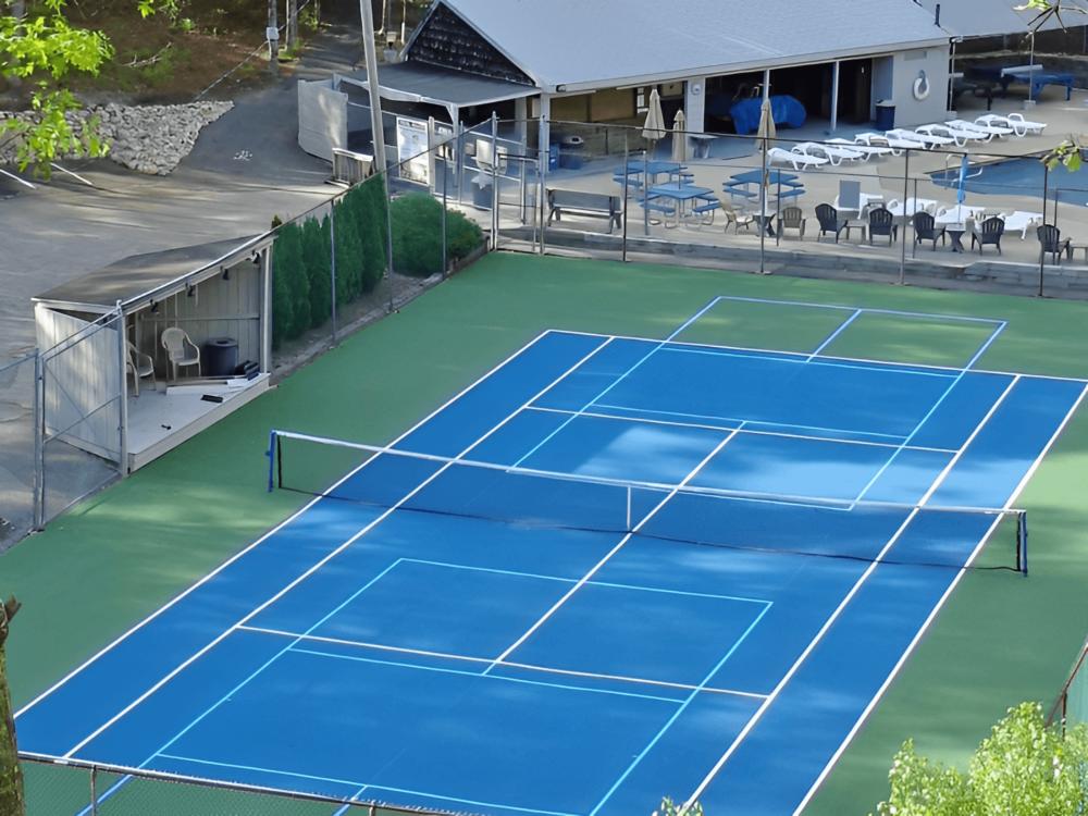 Tennis court and pool view at site Bay View Campground