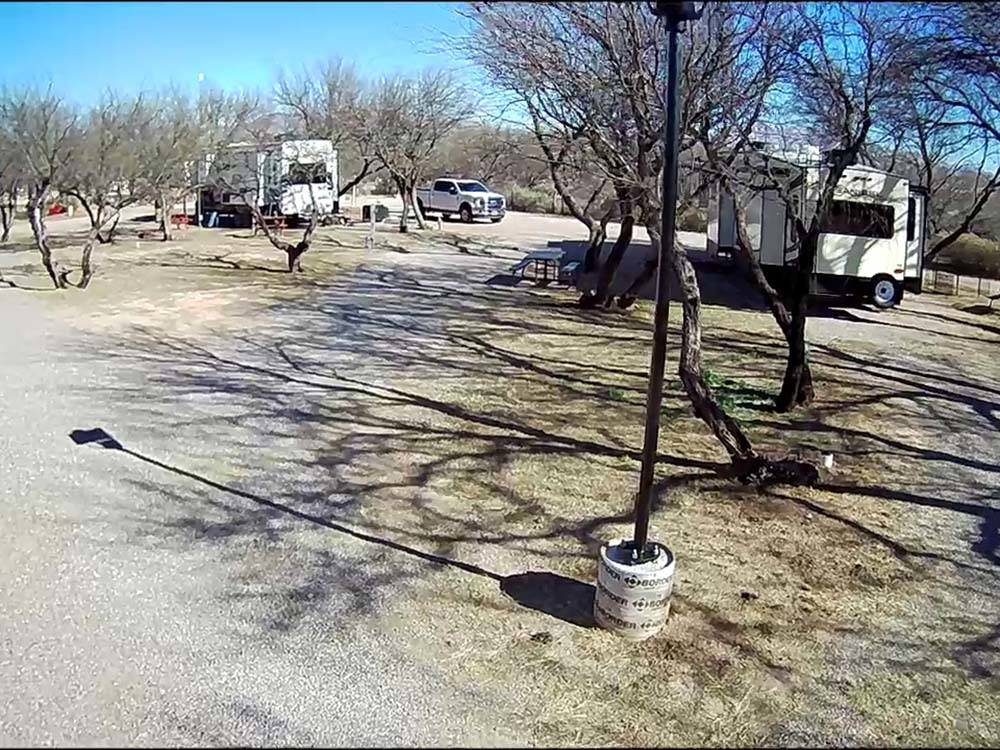An empty gravel site between two parked travel trailers at BENSON KOA JOURNEY