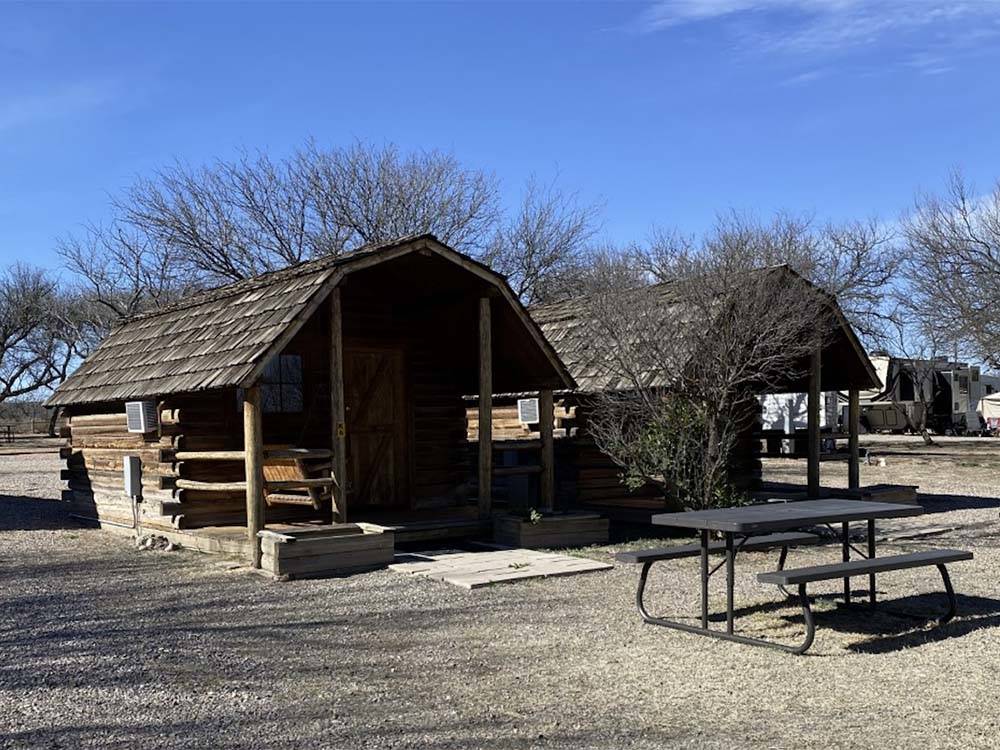 Two wooden cabins with a swing at BENSON KOA JOURNEY