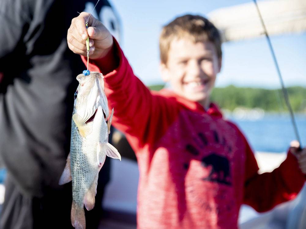 A boy holding a fish he caught